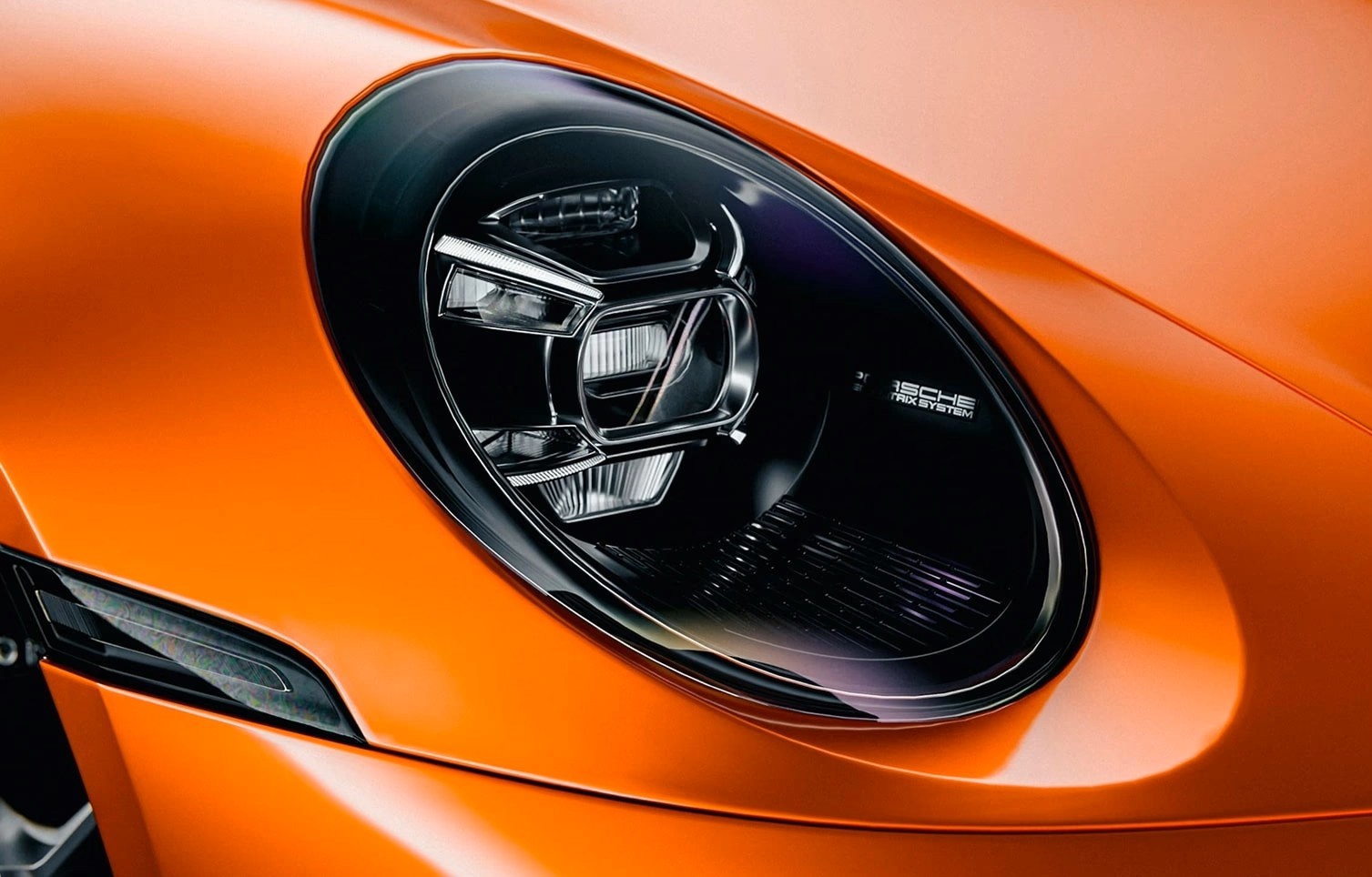 Porsche headlight and front body detail at Multi Tech Auto