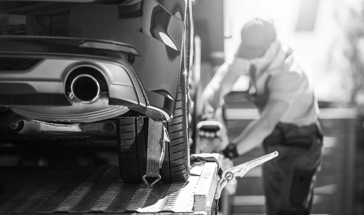 A person loading a car for tow
